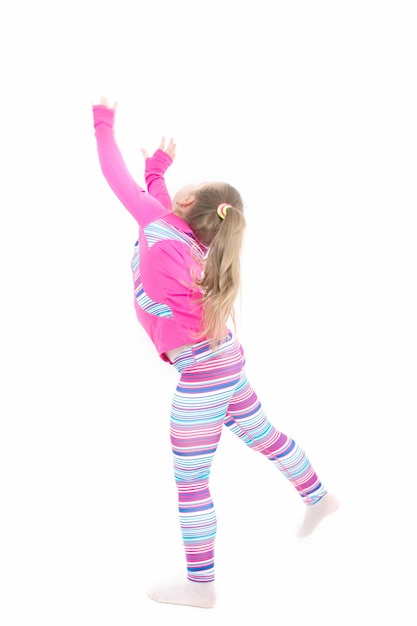 Fitness et santé. Éducation et énergie. Sport et réussite. Entraînement de petite fille isolée sur fond blanc. Enfant en tenue de sport rose., sport