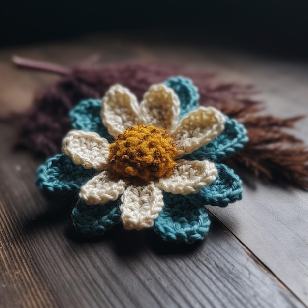 Une fleur au crochet est sur une table.