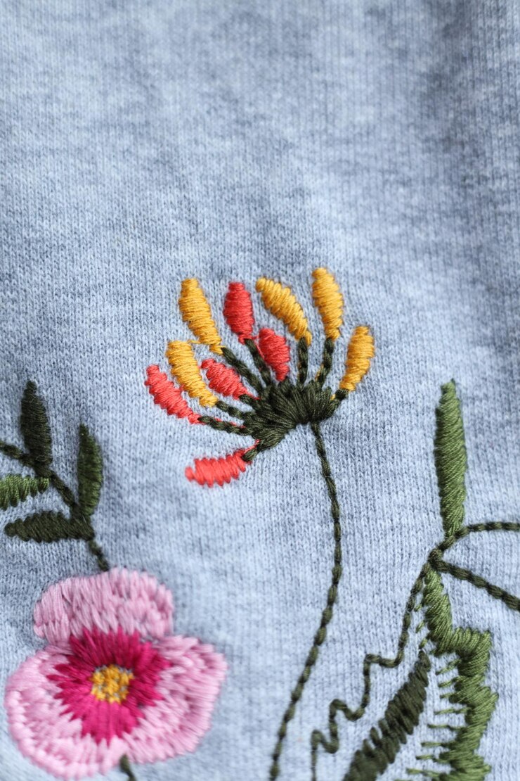 Photo fleur de broderie sur fond de tissu fabriqué à la main focus sélectif