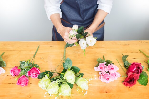 Fleuriste Arranger beau gilet artificiel au magasin de fleurs