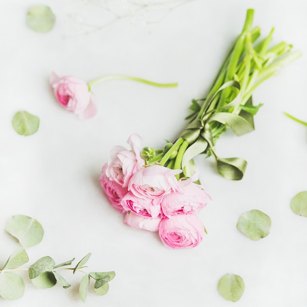 Fleurs de ranunkulus rose clair sur fond de marbre