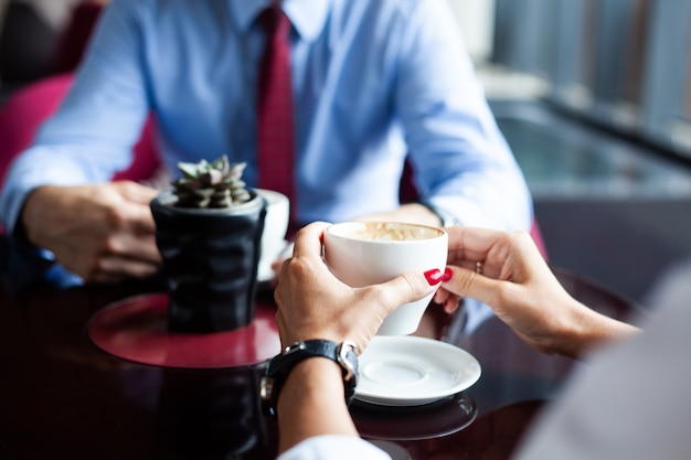 Flirter dans un café. Beau couple d'amoureux assis dans un café appréciant le café et la conversation. Amour et romantisme.