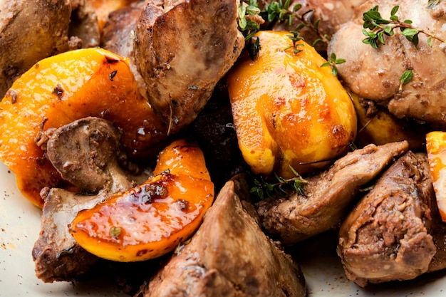 Foie frit délicieux avec des morceaux de coing. Fond de nourriture, gros plan