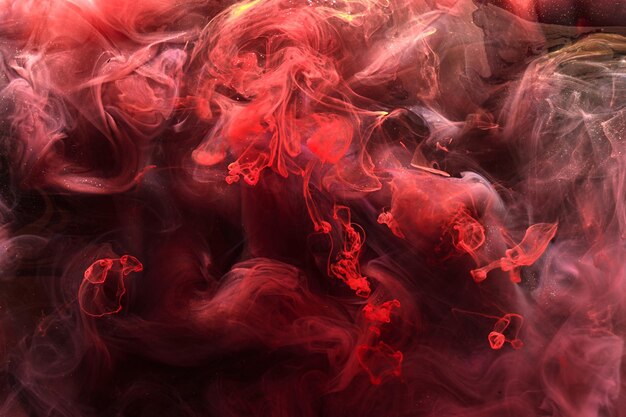Photo fond abstrait d'encre noire rouge toile de fond de peinture acrylique pour les cosmétiques de narguilé de parfum nuages de fumée mystérieux brouillard coloré