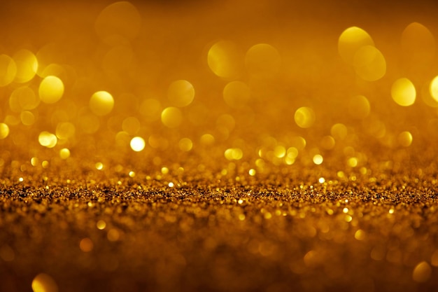 Fond abstrait avec des paillettes d'or et bokeh