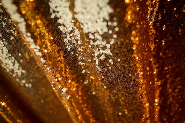 Fond abstrait avec des paillettes d'or couleur sur le tissu