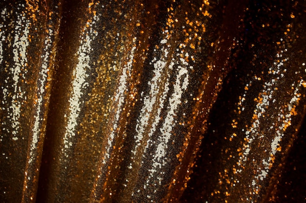 Fond abstrait avec des paillettes d'or couleur sur le tissu