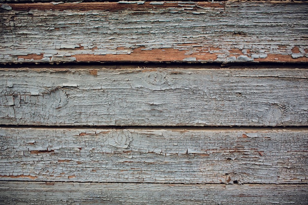 Fond bois vintage avec peinture écaillée.