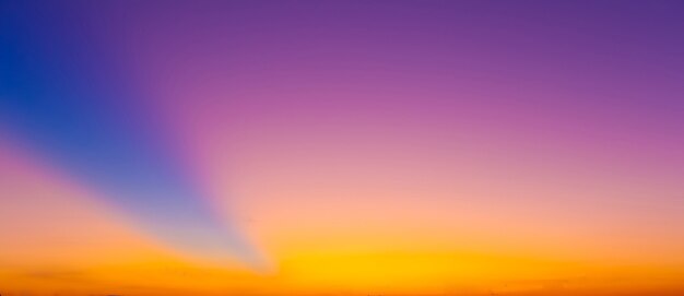 Le fond de ciel coloré flou du soleil crépusculaire en soirée.