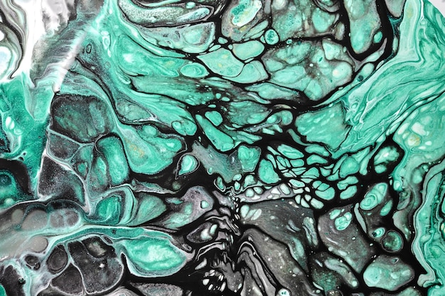Fond de couleur noir vert abstrait art fluide multicolore vagues éclaboussures et taches peintures à l'encre d'alcool acrylique sous l'eau