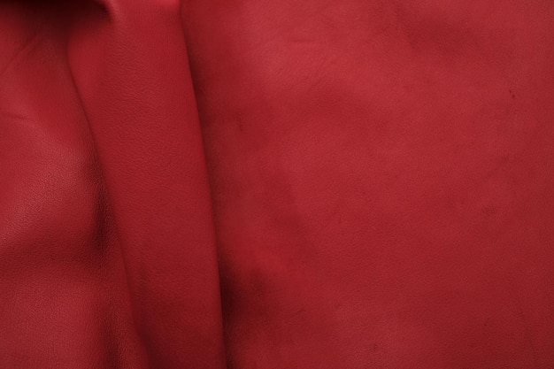 Fond en cuir rouge avec surface rugueuse cette photo en gros plan sous forme de selles