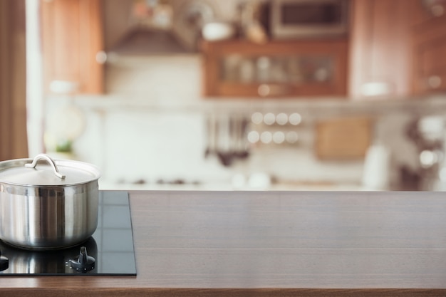 Fond de cuisine floue et abstraite. Plateau en bois avec casserole et cuisine moderne défocalisé.