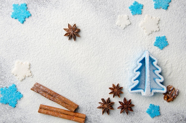 Fond de cuisine de Noël fait de farine, bâtons de cannelle, anis, emporte-pièce et pépites de sucre