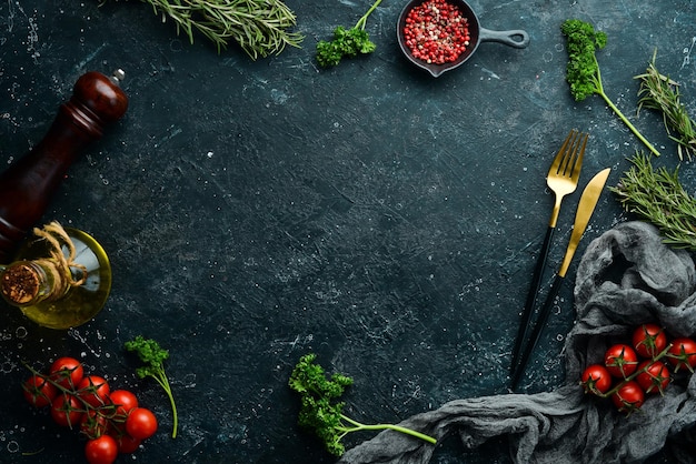 Fond de cuisine en pierre noire Planche de cuisine Légumes et épices sur fond noir Vue de dessus