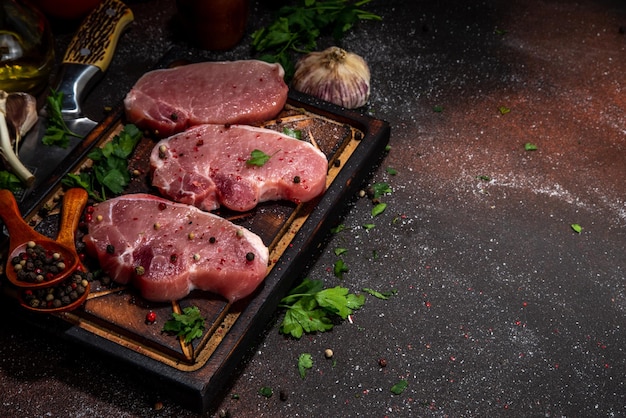Photo fond de cuisson de steaks de viande de porc cru