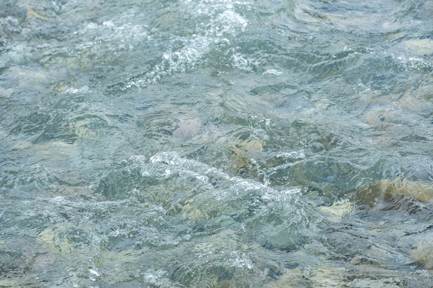 fond de l'eau de la rivière claire de la montagne