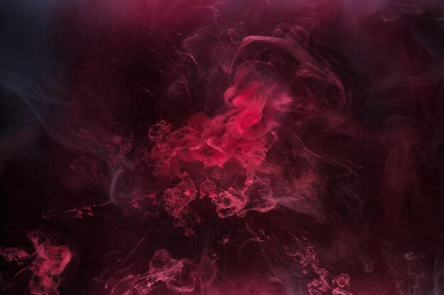 Fond d'encre noir et rouge brouillard coloré abstrait tourbillonnant océan peinture acrylique pigment sous-marin fumée sombre