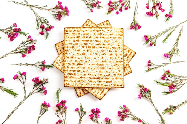 Fond de fête juive de Pâque avec Matzah et fleurs sur fond blanc concept de fête juive de Pâque