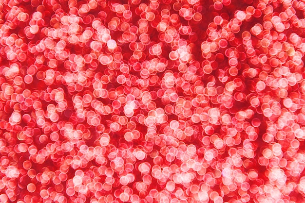 Fond flou de bokeh de paillettes rouges