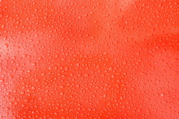 Fond de gouttes d'eau sur un avion rouge