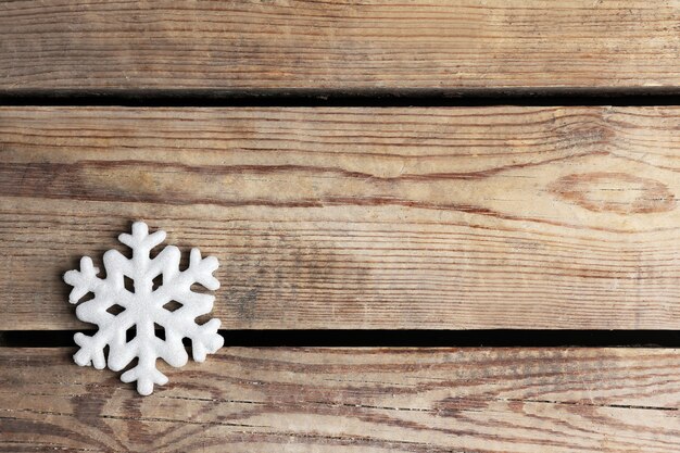 Fond d'hiver avec flocon de neige sur fond de bois