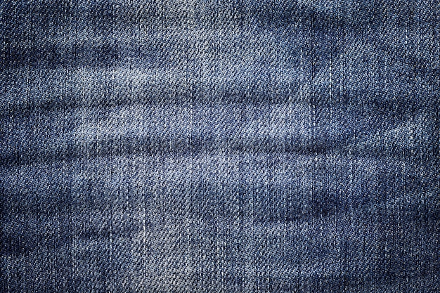 Fond de jeans foncé. Texture denim classique. Surface de vêtements de mode.