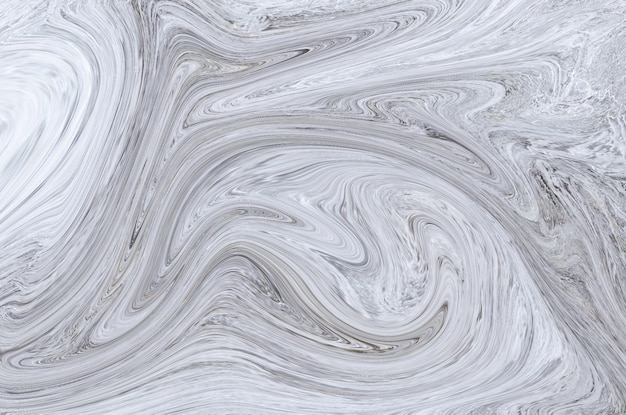 Un fond de marbre gris et blanc avec un motif de tourbillon.