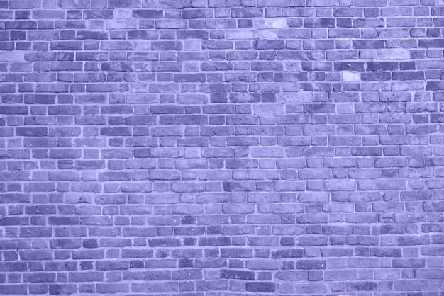 Fond de mur de brique mur violet fissuré et texturé La couleur du concept 2022 Gros plan