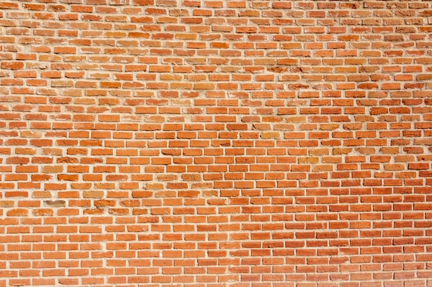 Fond de mur de brique orange.