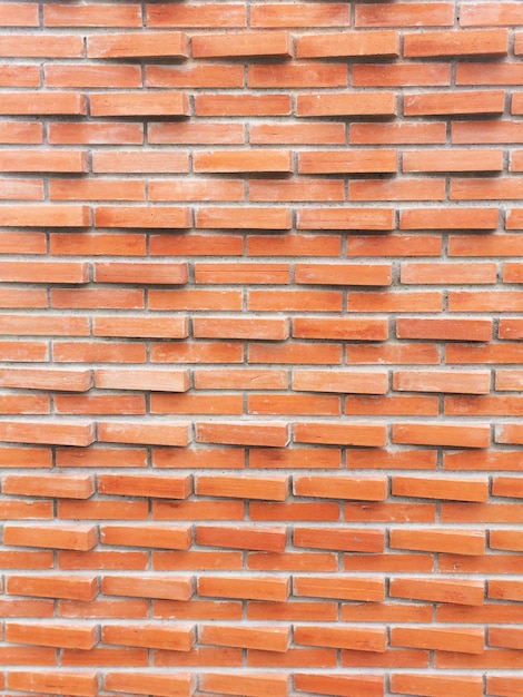 Fond de mur de briques rouges.