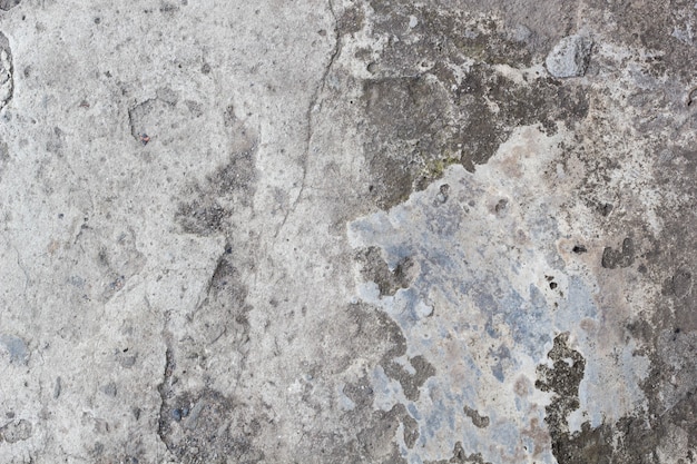 Fond de mur en pierre fissurée gris clair, béton