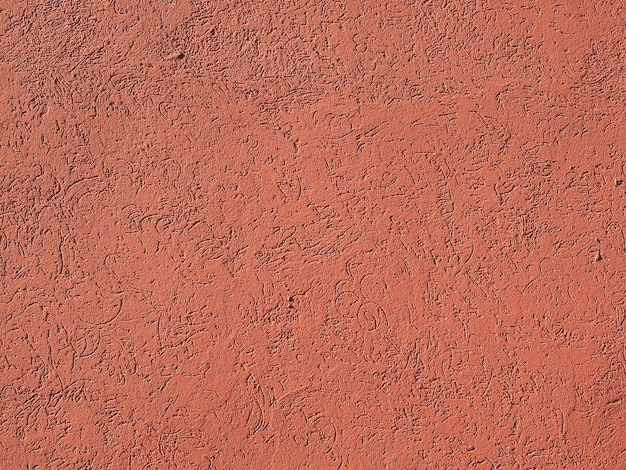 Fond de mur de plâtre rouge