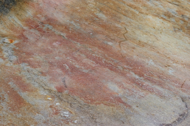 Fond de mur de texture de surface en pierre de marbre brun rouge naturel.