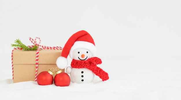 Fond de Noël avec bonhomme de neige, boîte-cadeau et ornements de Noël