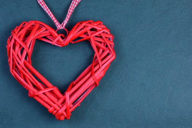 Sur un fond ondulé vert décoratif sur le côté gauche, il y a un grand coeur rouge décoratif. Sur la droite il y a une place pour l'inscription le jour de la Saint-Valentin