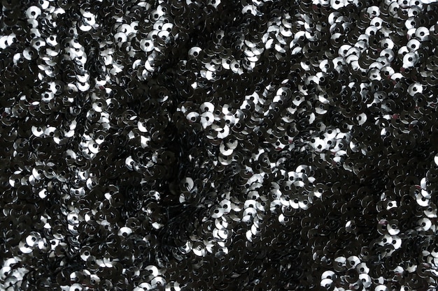 fond de paillettes noir. Tissu noir chatoyant.