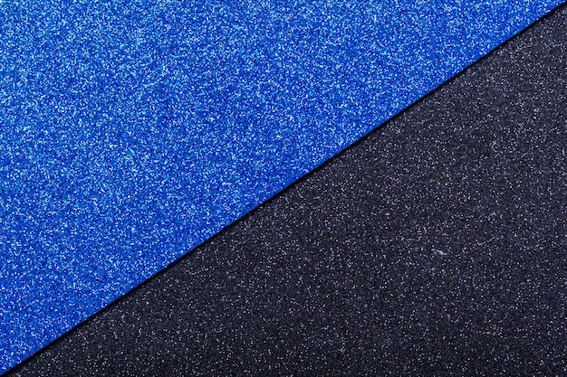 Fond de papier d'emballage noir et bleu avec éclat métallique Double couleur noir bleu brillant papier fond copie espace mode texture concept minimal plat poser vue de dessus