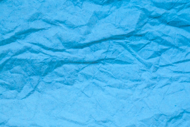 Fond de papier froissé bleu.