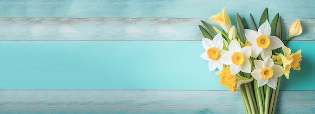 Fond de pâques de printemps avec vue de dessus du bouquet de jonquilles sur une table en bois bleu clair avec espace de copie