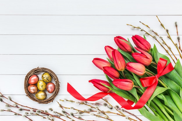 Fond de Pâques. Tulipes, saules et œufs de Pâques.