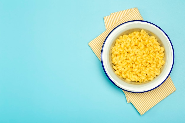 Photo fond de pâtes. macaroni au fromage sur fond bleu.