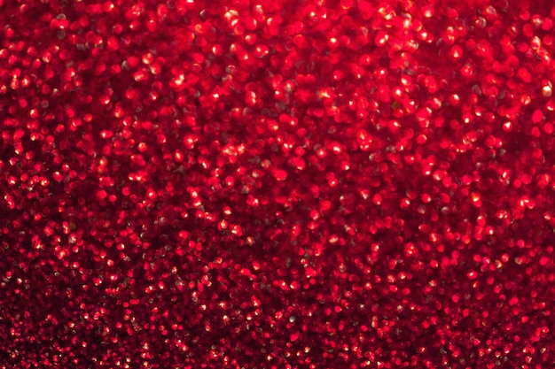 Fond rouge brillant flou avec des lumières scintillantes.