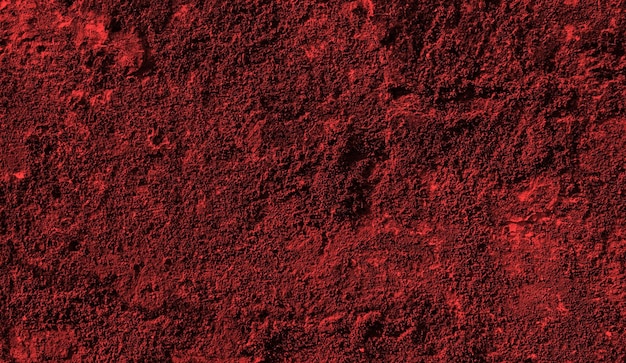Un fond rouge avec une surface texturée et le mot rouge dessus.