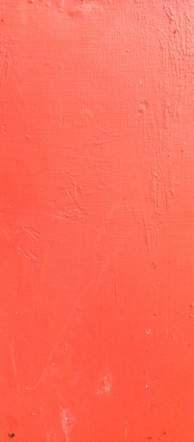 Un fond rouge avec une texture de mur.