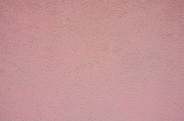 Fond rugueux rose de texture de mur plâtré