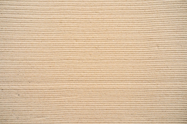 Fond de sable texturé sur la plage.