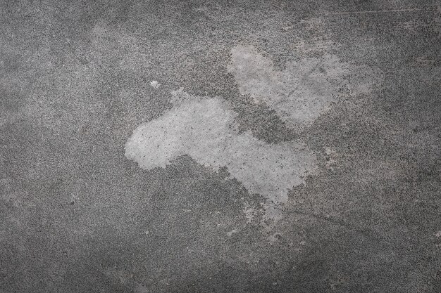 Fond de stuc gris texturé avec rayures, éraflures et taches. fond de plâtre pour l'espace de copie