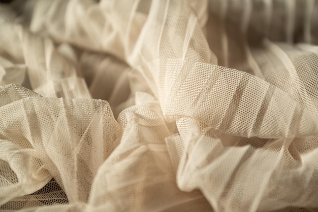Photo fond textile drapé en tulle de couleur beige