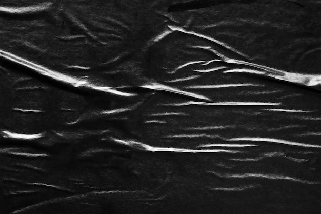 Photo fond de texture d'affiche de papier froissé et froissé noir