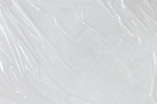 Photo fond de texture d'affiche en plastique froissé et froissé transparent blanc film plastique humide sur fond blanc